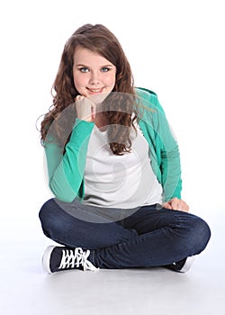 Happy teenage student girl sitting cross legged