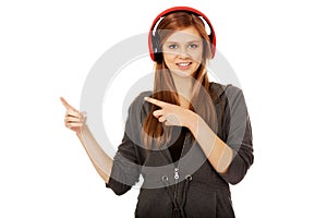 Happy teenage woman pointing for something