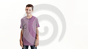 Happy teenaged disabled boy with cerebral palsy smiling at camera while posing, standing isolated over white background