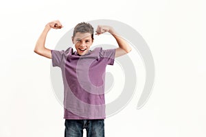 Happy teenaged disabled boy with cerebral palsy smiling at camera and raising clenched fists, feeling strong, posing