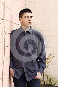 Happy teenager boy grimace wink closeup portrait on white wall background