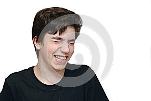 Happy teenager boy laughing closeup portrait isolated on white