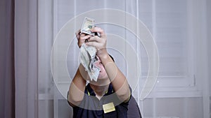 Happy Teenager Catching with Hands Falling 100 Dollar Bills Flying on his Head