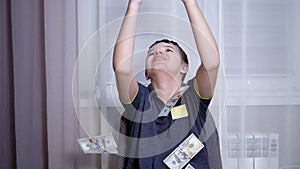 Happy Teenager Catching with Hands Falling 100 Dollar Bills Flying on his Head