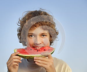 Happy teenager eating watermelon