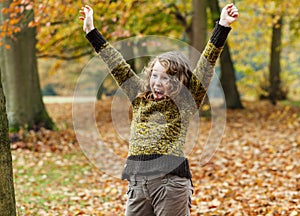 Happy teenager girl in autumn park