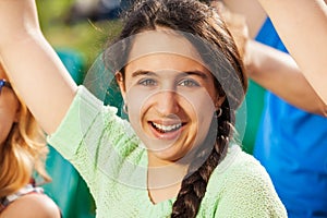 Happy teenager girl cheer for the team during game