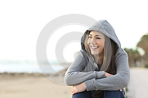 Happy teenager girl looking at side outdoors photo