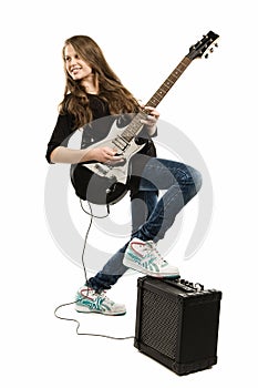 Happy teenager girl playing guitar