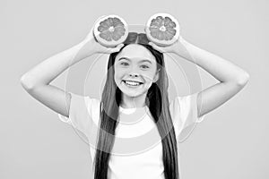 Happy teenager girl in t-shirt hold grapefruit orange, kids fruits vitamin.