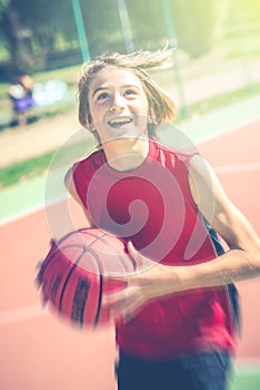 Happy teenager play basketball outdoor healthy sporty teenagers lifestyle concept in spring or summer time