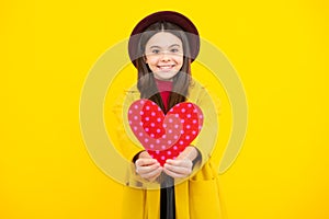 Happy teenager portrait. Happiness kids and love concept. Romantic lovely teen girl with red heart, world heart day