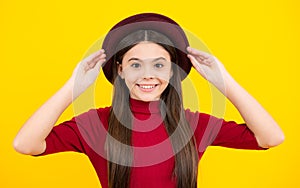 Happy teenager portrait. Portrait of beautiful happy smiling teenage girl on yellow studio background. Smiling girl.