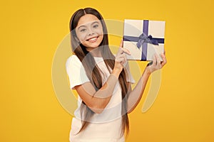Happy teenager portrait. Teenager kid with present box. Teen girl giving birthday gift. Present, greeting and gifting