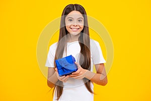 Happy teenager portrait. Teenager kid with present box. Teen girl giving birthday gift. Present, greeting and gifting