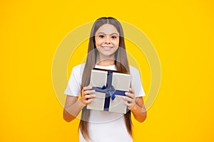Happy teenager portrait. Teenager kid with present box. Teen girl giving birthday gift. Present, greeting and gifting photo