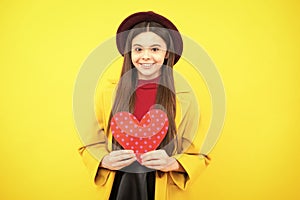 Happy teenager portrait. Young teenager child girl with heart shape. Happy Valentines Day. Love and pleasant feelings