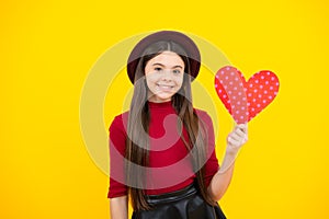 Happy teenager portrait. Young teenager child girl with heart shape. Happy Valentines Day. Love and pleasant feelings