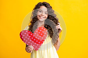 Happy teenager portrait. Young teenager child girl with heart shape. Happy Valentines Day. Love and pleasant feelings