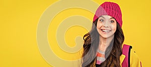 Happy teenager, positive and smiling emotions of teen girl. Children studio portrait on yellow background. Child face