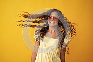 Happy teenager, positive and smiling emotions of teen girl. Teenager portrait with crazy movement hair. Young teen child