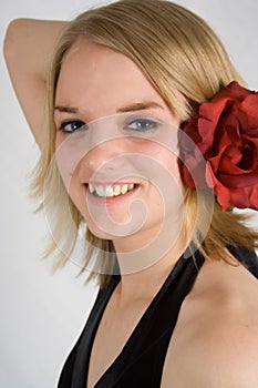 Happy teenager with red rose