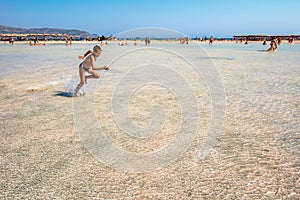 Happy teenager running at the sand beach