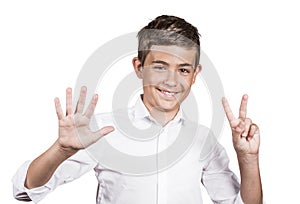Happy teenager showing seven fingers, number 7 gesture photo