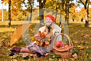 Happy teenager smiling. Autumn portrait of beautiful young girl in red hat