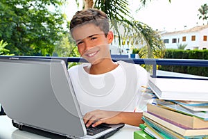 Happy teenager student boy working laptop