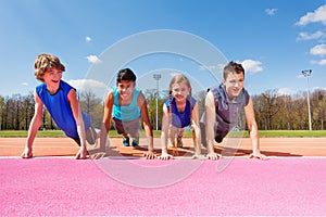 Happy teenagers doing push-up exercises outdoor