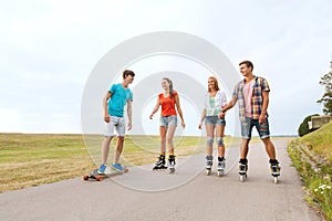 Happy teenagers with rollerblades and longboards