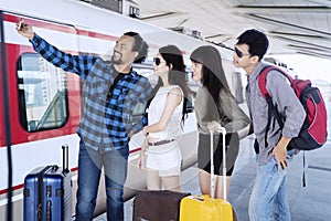 Happy teenagers taking selfie photo in station