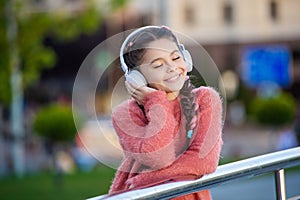 Happy teener enjoy listening to music. Melomaniac teenager listening song outdoors