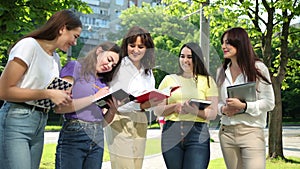 Happy Teens girls Studying Together Outdoors, Enjoying Life. Students books