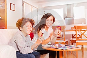 Happy teens playing card games in the living room