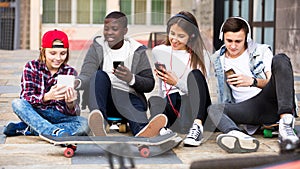 Happy teens playing on smarthphones