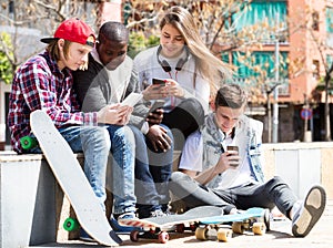 Happy teens playing on smarthphones