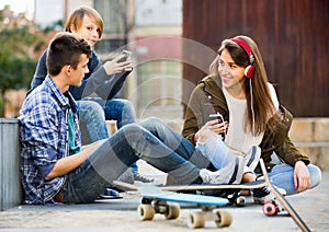 Happy teens playing on smarthphones