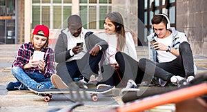 Happy teens playing on smarthphones