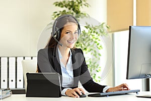 Happy tele marketer working looking at camera at office