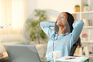 Happy tele worker relaxing breathing at home photo