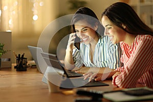 Happy tele workers using multiple devices at home