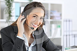 Happy telemarketer posing looking camera at office