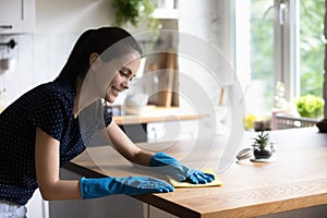 Happy tenant girl in blue protective rubber gloves enjoying cleanup