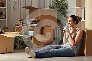 Happy tenant resting drinking coffee moving home photo