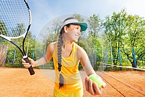 Happy tennis player preparing to serve outdoors