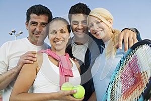 Happy Tennis Players With Rackets And Balls Against Sky