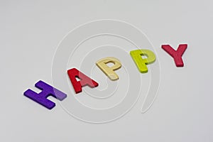 The HAPPY text from colorful wooden letters is on white background