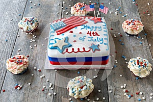 Happy 4th of July cake surrounded by cupcakes